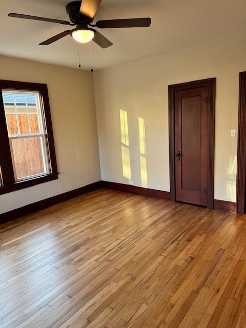 empty room featuring ceiling fan and light wood-type flooring