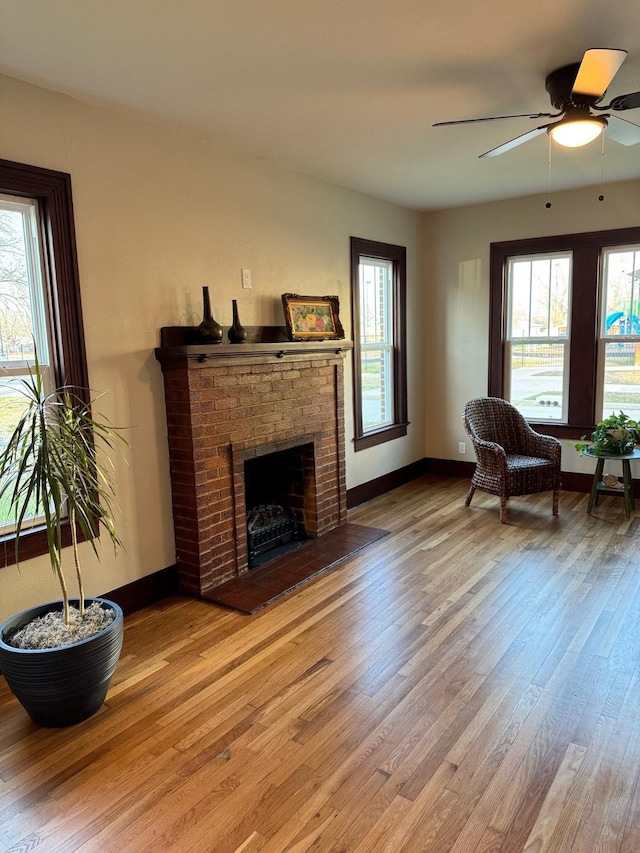 living room with plenty of natural light, a fireplace, and light hardwood / wood-style flooring