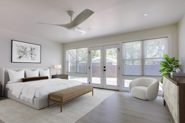 bedroom with ceiling fan, access to outside, light wood-type flooring, and french doors