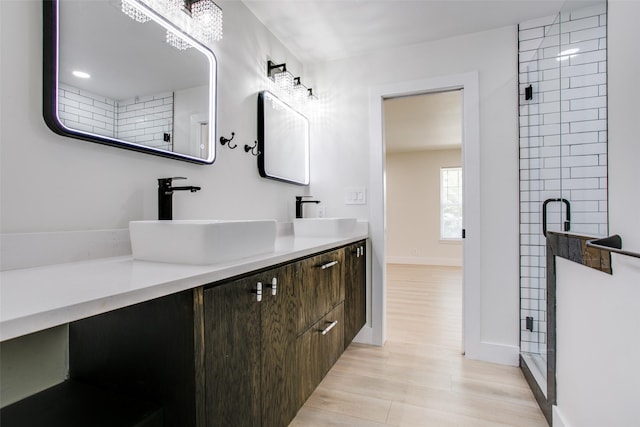 bathroom featuring an enclosed shower, vanity, and hardwood / wood-style flooring