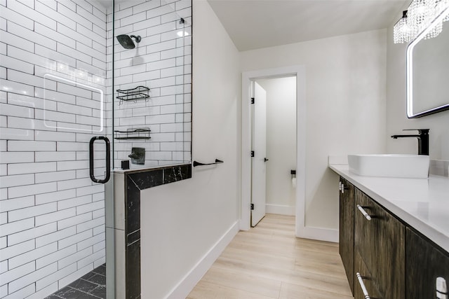 bathroom with vanity, a shower with door, and wood-type flooring