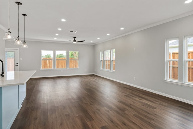 unfurnished living room with ornamental molding, dark wood-type flooring, and ceiling fan