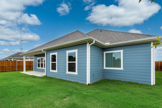 rear view of property with a patio area and a lawn