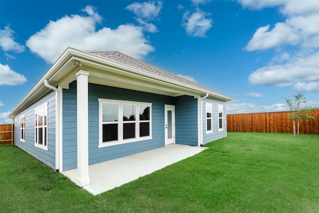 back of house with a patio and a yard