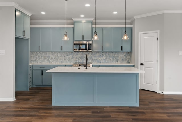 kitchen with crown molding, tasteful backsplash, hanging light fixtures, dark hardwood / wood-style flooring, and a kitchen island with sink