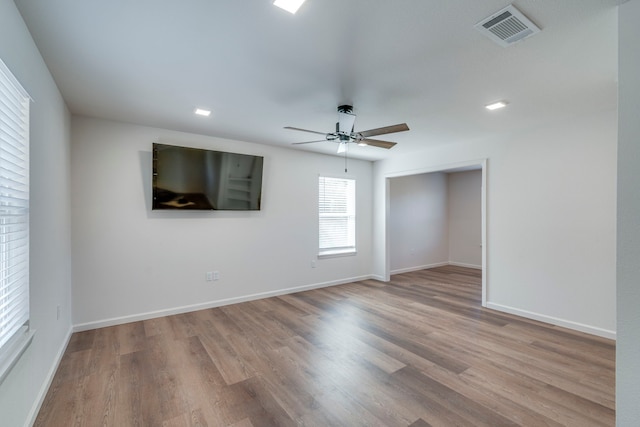 empty room featuring ceiling fan and light wood-type flooring