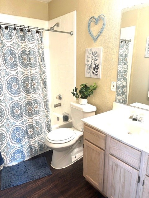 full bathroom featuring shower / bath combination with curtain, wood-type flooring, toilet, and vanity