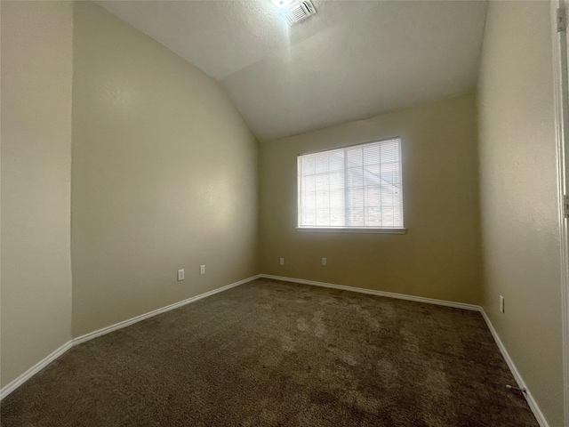 unfurnished room with vaulted ceiling and carpet flooring