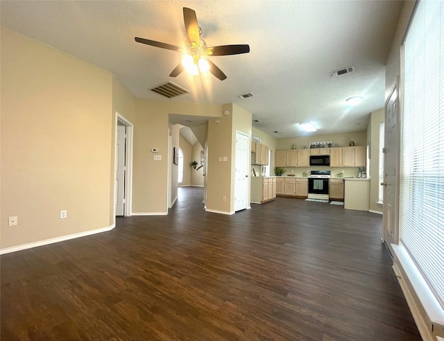 unfurnished living room with ceiling fan, dark hardwood / wood-style floors, and a textured ceiling