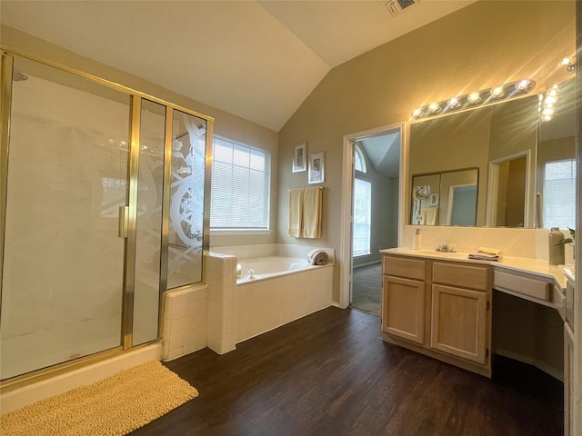 bathroom featuring vanity, shower with separate bathtub, vaulted ceiling, and hardwood / wood-style floors