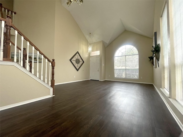 interior space with dark wood-type flooring and high vaulted ceiling