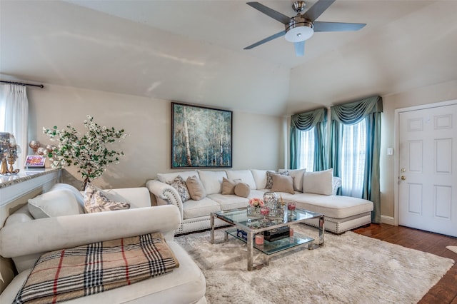 living room featuring ceiling fan, lofted ceiling, and dark hardwood / wood-style floors