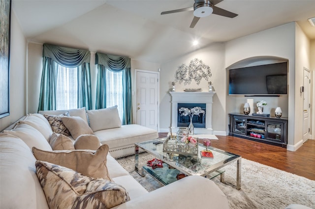 living room with lofted ceiling, hardwood / wood-style floors, and ceiling fan