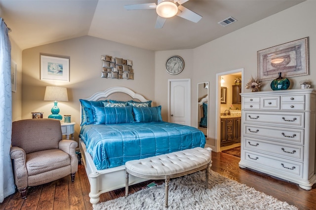 bedroom with ceiling fan, ensuite bathroom, dark hardwood / wood-style floors, and vaulted ceiling