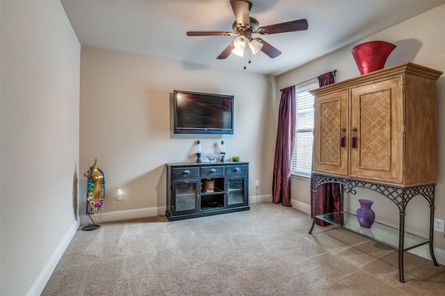 interior space featuring ceiling fan and light colored carpet