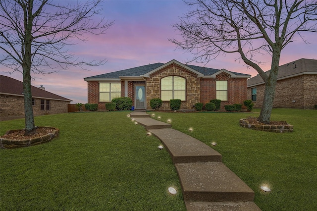 ranch-style house featuring a lawn