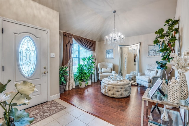 tiled entrance foyer with a chandelier