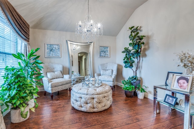 sitting room featuring vaulted ceiling, dark hardwood / wood-style floors, and a chandelier