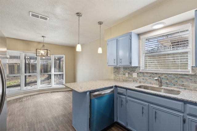 kitchen with blue cabinets, sink, hanging light fixtures, stainless steel dishwasher, and kitchen peninsula