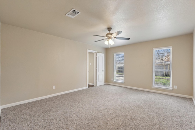 carpeted empty room featuring a textured ceiling and ceiling fan