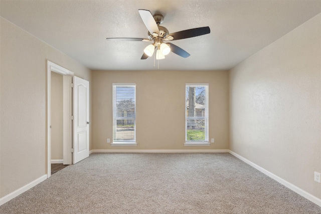 spare room with ceiling fan, carpet floors, and a textured ceiling