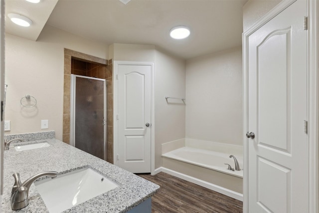 bathroom featuring vanity, hardwood / wood-style flooring, and separate shower and tub