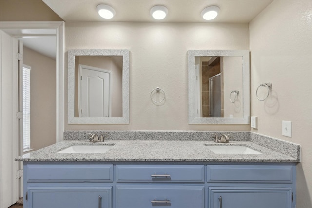 bathroom with vanity and an enclosed shower