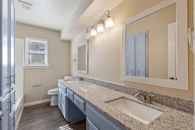 bathroom featuring hardwood / wood-style flooring, vanity, and toilet