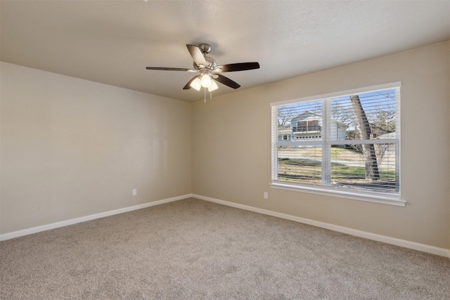 carpeted empty room with a textured ceiling and ceiling fan