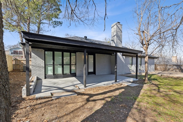 back of property with a patio