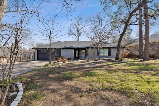 ranch-style house featuring a garage and a front yard