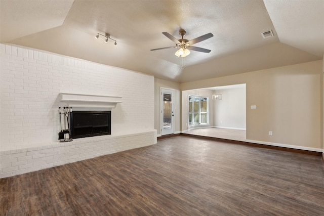 unfurnished living room with lofted ceiling, dark wood-type flooring, and ceiling fan