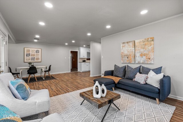 unfurnished living room featuring ornamental molding and hardwood / wood-style floors