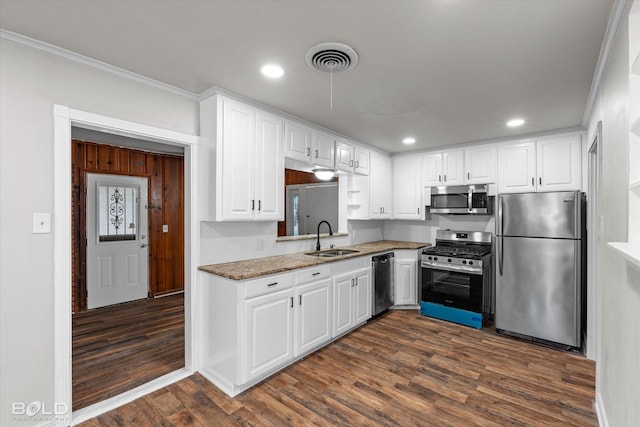 kitchen with stainless steel appliances, white cabinetry, a sink, and visible vents