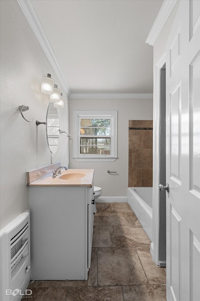 full bath featuring a tub to relax in, crown molding, heating unit, toilet, and vanity