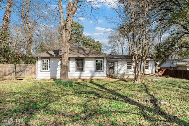 view of front of home featuring a patio, a front yard, fence, and a gate