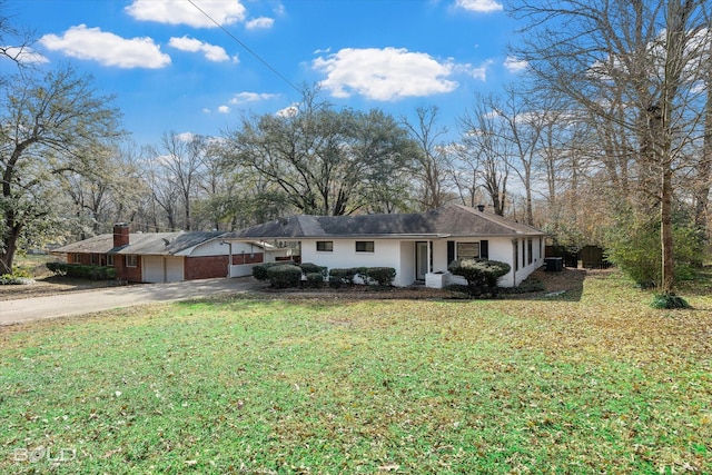 ranch-style home with a garage and a front yard