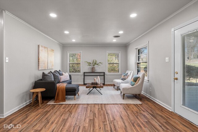 interior space featuring ornamental molding, brick wall, and hardwood / wood-style floors