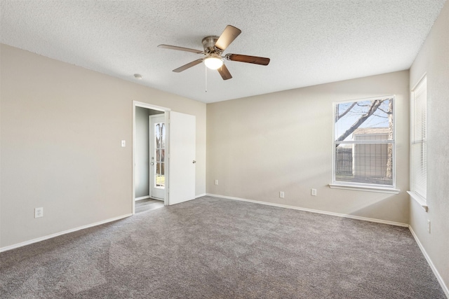 carpeted spare room with ceiling fan and a textured ceiling