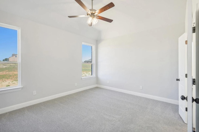 carpeted spare room featuring ceiling fan