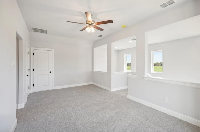 carpeted empty room featuring ceiling fan