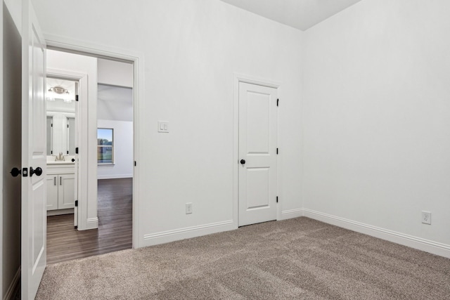 empty room with dark colored carpet