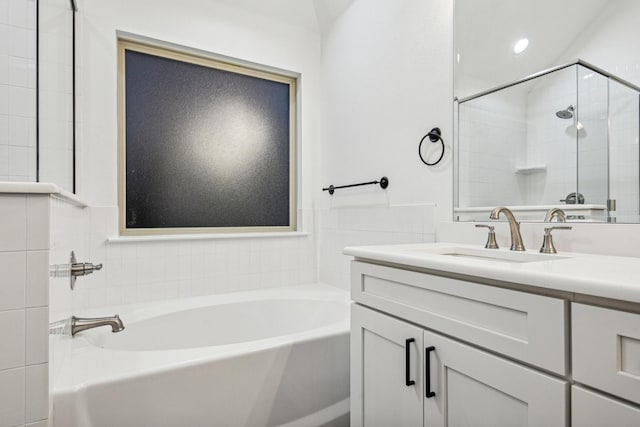 bathroom featuring vanity and separate shower and tub