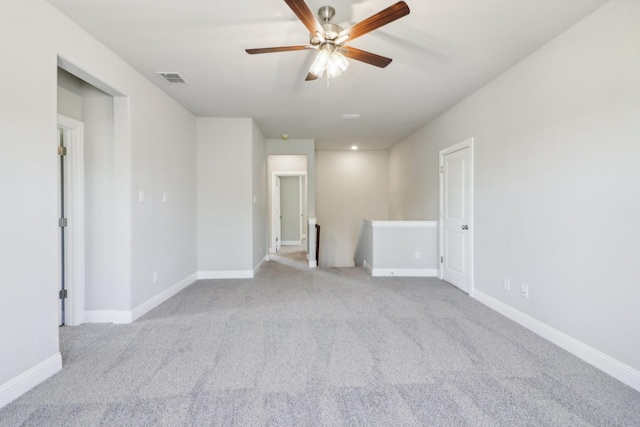 carpeted spare room featuring ceiling fan