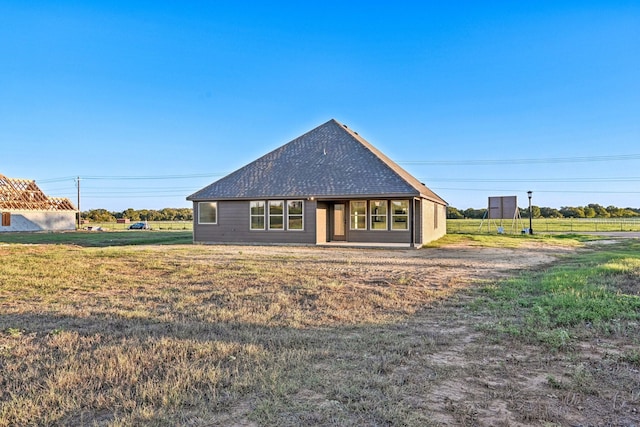 back of property featuring a yard