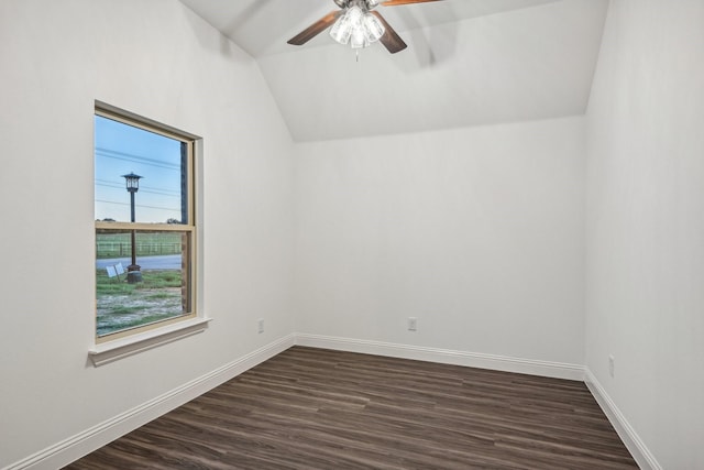 spare room featuring lofted ceiling, dark wood-type flooring, and ceiling fan