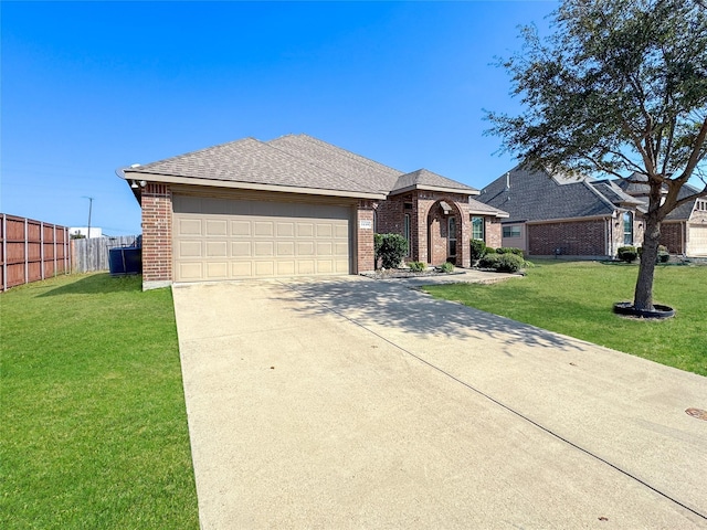 ranch-style home with a garage and a front lawn