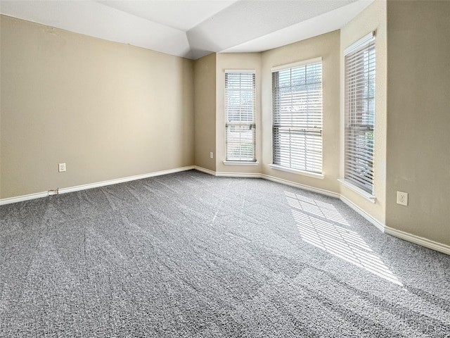 unfurnished room with lofted ceiling and carpet flooring