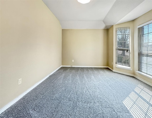 spare room with lofted ceiling and carpet floors