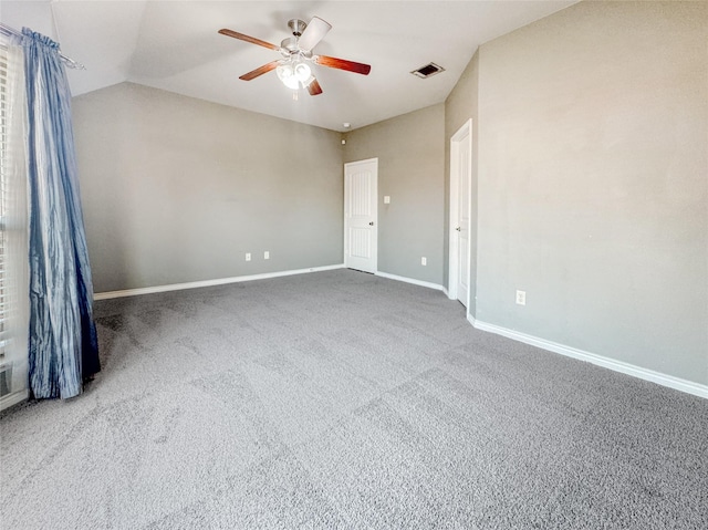 empty room featuring carpet floors, ceiling fan, and vaulted ceiling